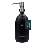 Black body wash bottle with pump and 'Kushi' label on a white background