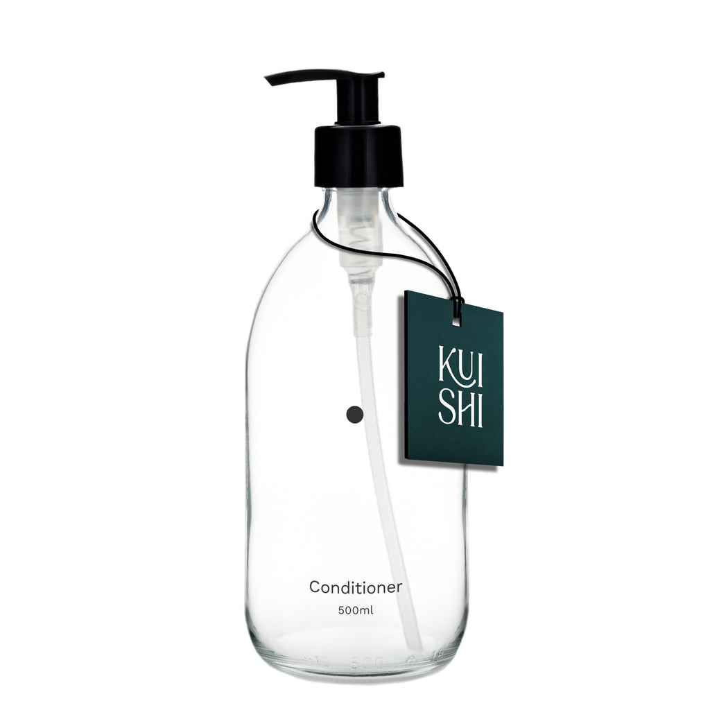 Clear conditioner bottle with black pump and 'KUSHI' label on a white background