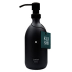 Black lotion bottle with pump and 'Kushi' tag on a white background
