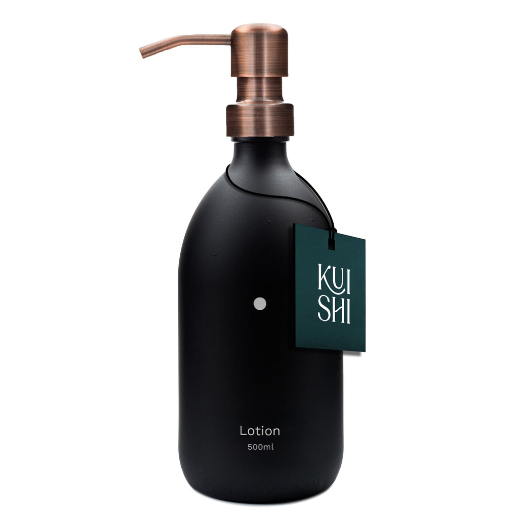 Black lotion bottle with copper pump and 'Kushi' tag on a white background