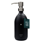 Black lotion bottle with silver pump and 'Kushi' tag on a white background