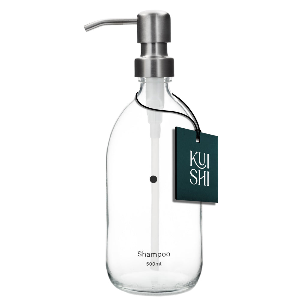 Clear glass shampoo bottle with pump and 'KUSHI' label on a white background