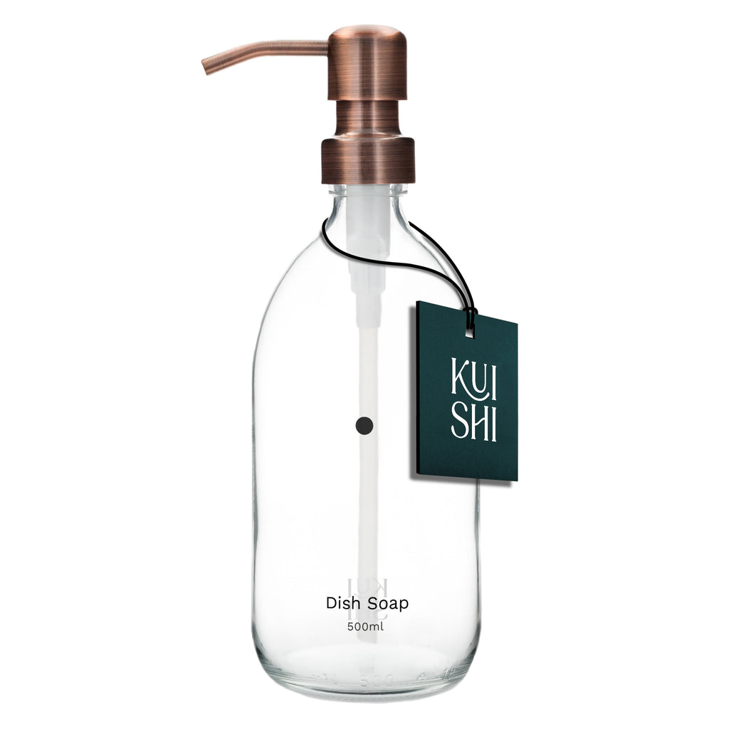 Clear dish soap bottle with copper pump and 'Kushi' label on a white background