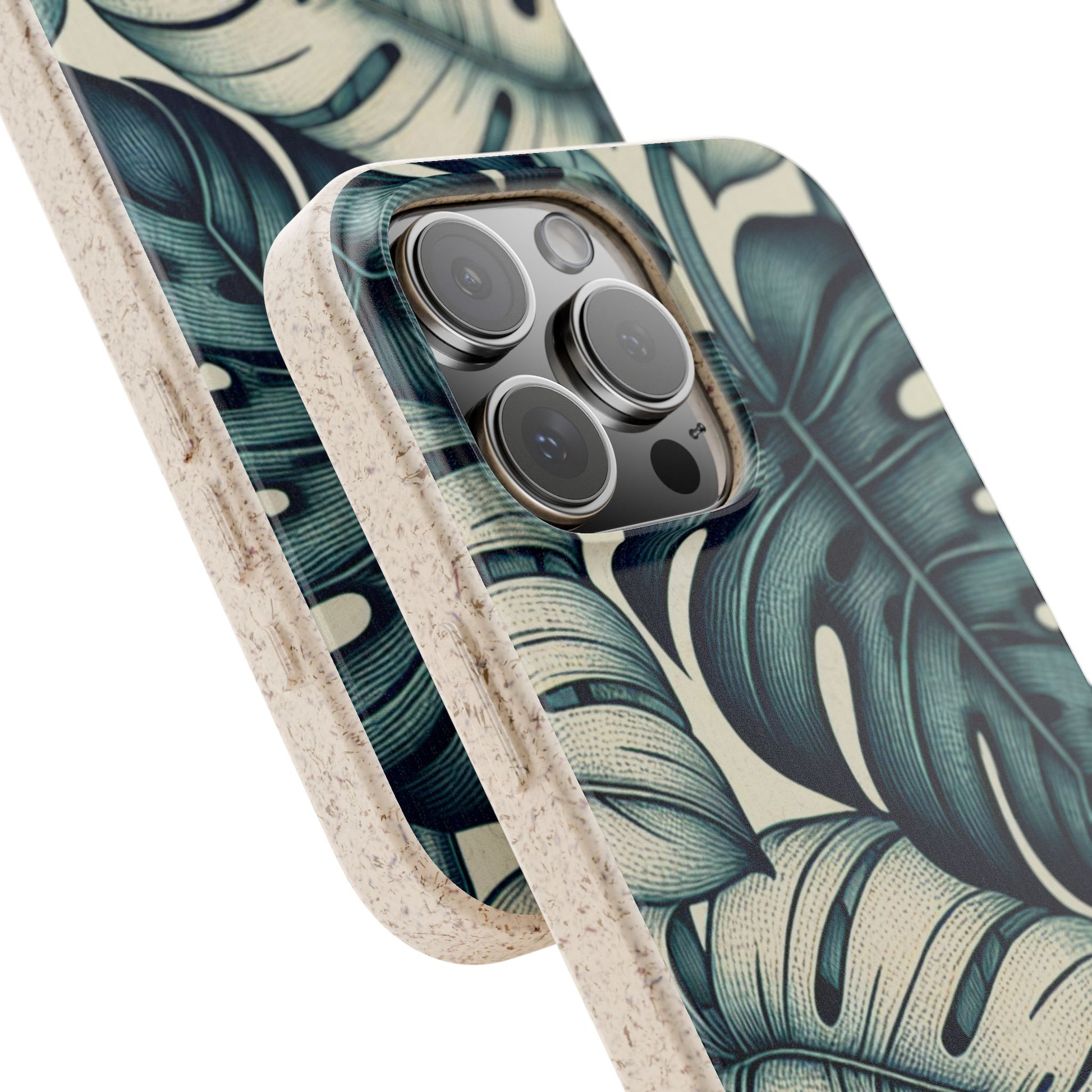 A beige, speckled Monstera Eco-friendly iPhone 16 Pro Max Case with a teal and blue monstera leaf pattern on a light background. The case is angled to show the back and side, highlighting the camera cutout and the textured material. Another matching phone case is blurred in the background.






