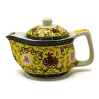 Yellow ceramic teapot with intricate designs on a white background from MVB STUDIO official store.