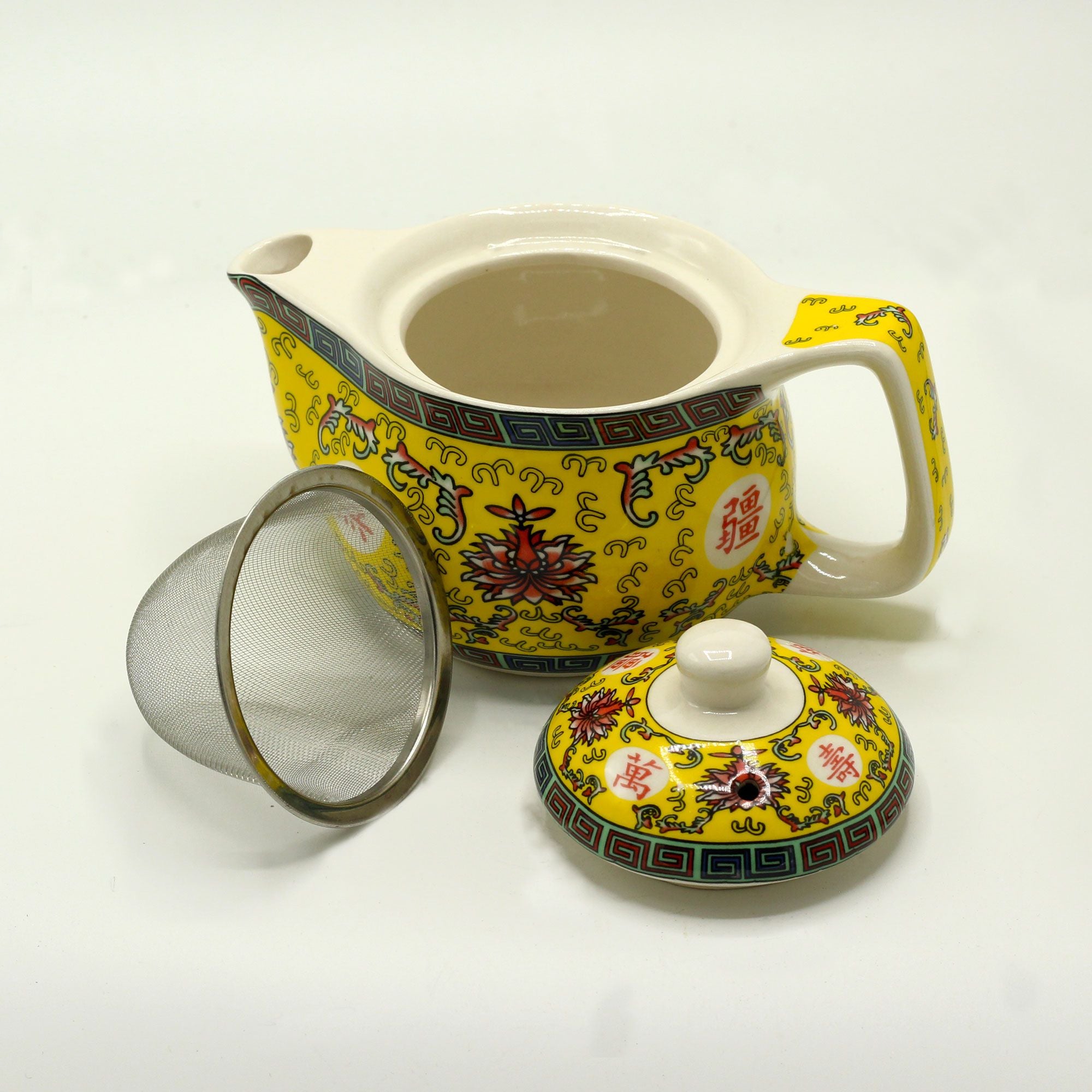 Yellow ceramic teapot with floral patterns on a white background from MVB STUDIO official store.