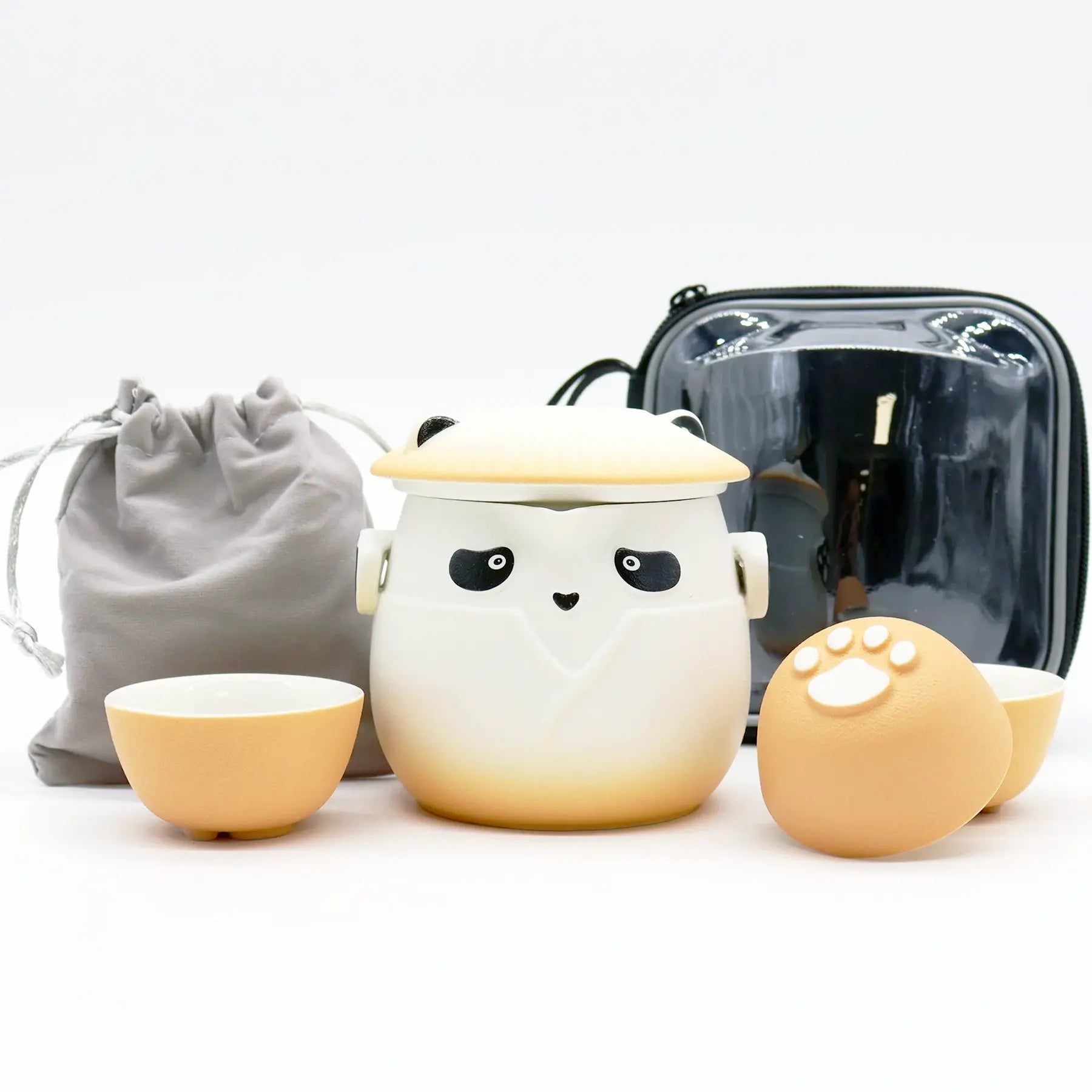 Ceramic tea set with panda design, including a teapot, two cups, and a small container on a white background.