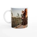 Mug with a printed photo of a woman holding a child on a wooden bridge.