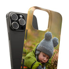 Personalised Slim Case iPhone 16 Pro Max with a child wearing a knitted hat and green jacket on a blurred natural background
