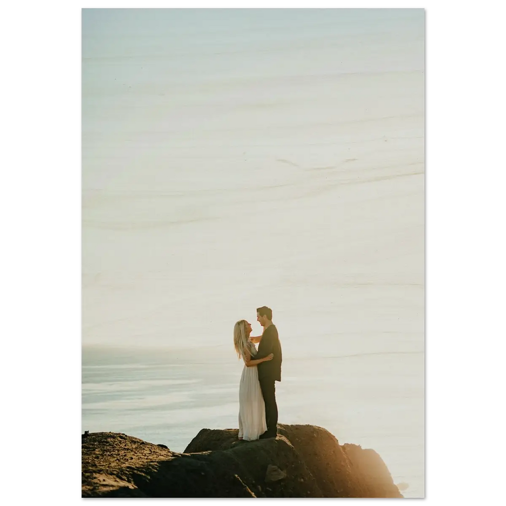 Couple embracing on a rocky outcrop with a scenic background wood print.