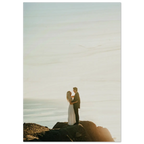 Couple embracing on a rocky outcrop with a scenic background wood print.