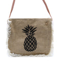 Jute bag with pineapple design and fringes on a white background