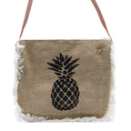 Jute bag with pineapple design and fringes on a white background