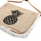 Jute bag with pineapple design and frayed edges on a white background