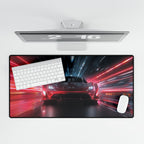 Large desk mat with a car and keyboard design, placed below a computer monitor.