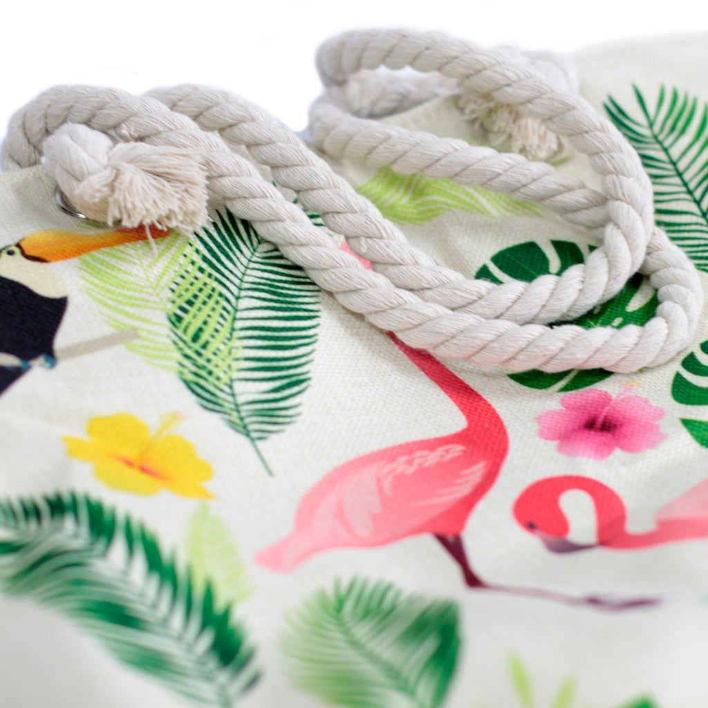 Tropical-themed fabric with flamingo and leaf patterns and a coiled rope.