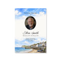 Memorial card with a photo of a man, text, and a coastal scene.