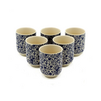 Set of six ceramic cups with blue floral patterns on a white background