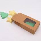 Carton box with window displaying green and blue tree-shaped objects on a white background