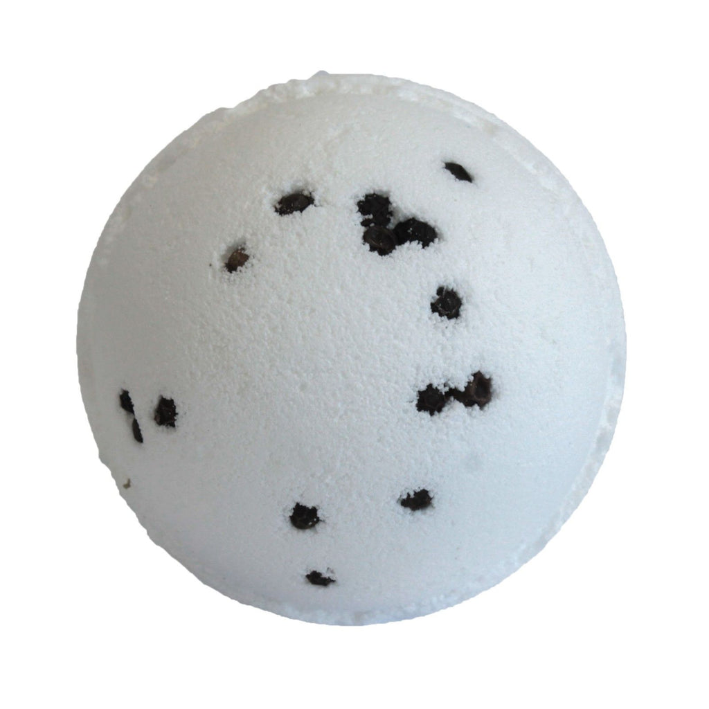 White bath bomb with black specks on a white background