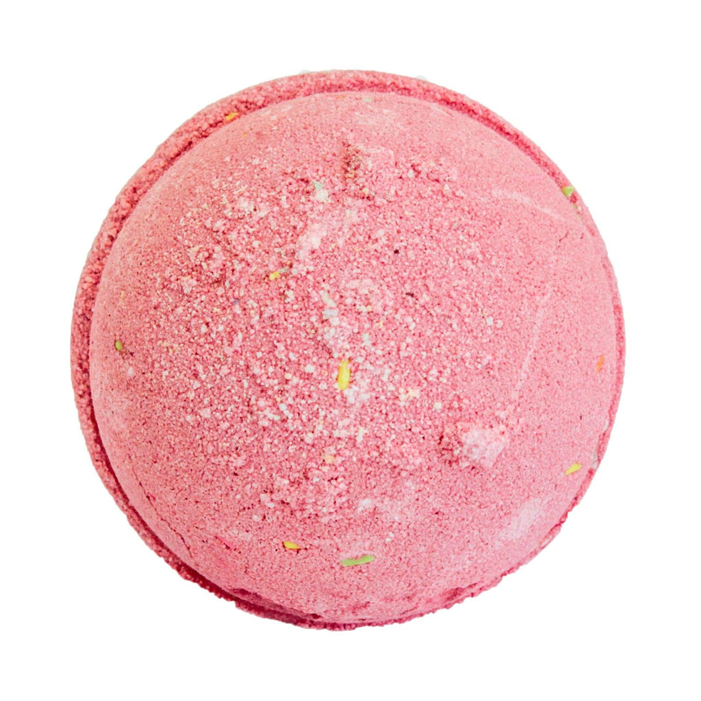 Pink bath bomb with specks on a white background