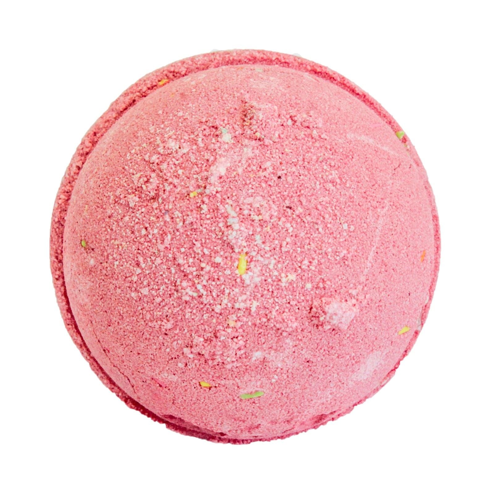 Pink bath bomb with specks on a white background