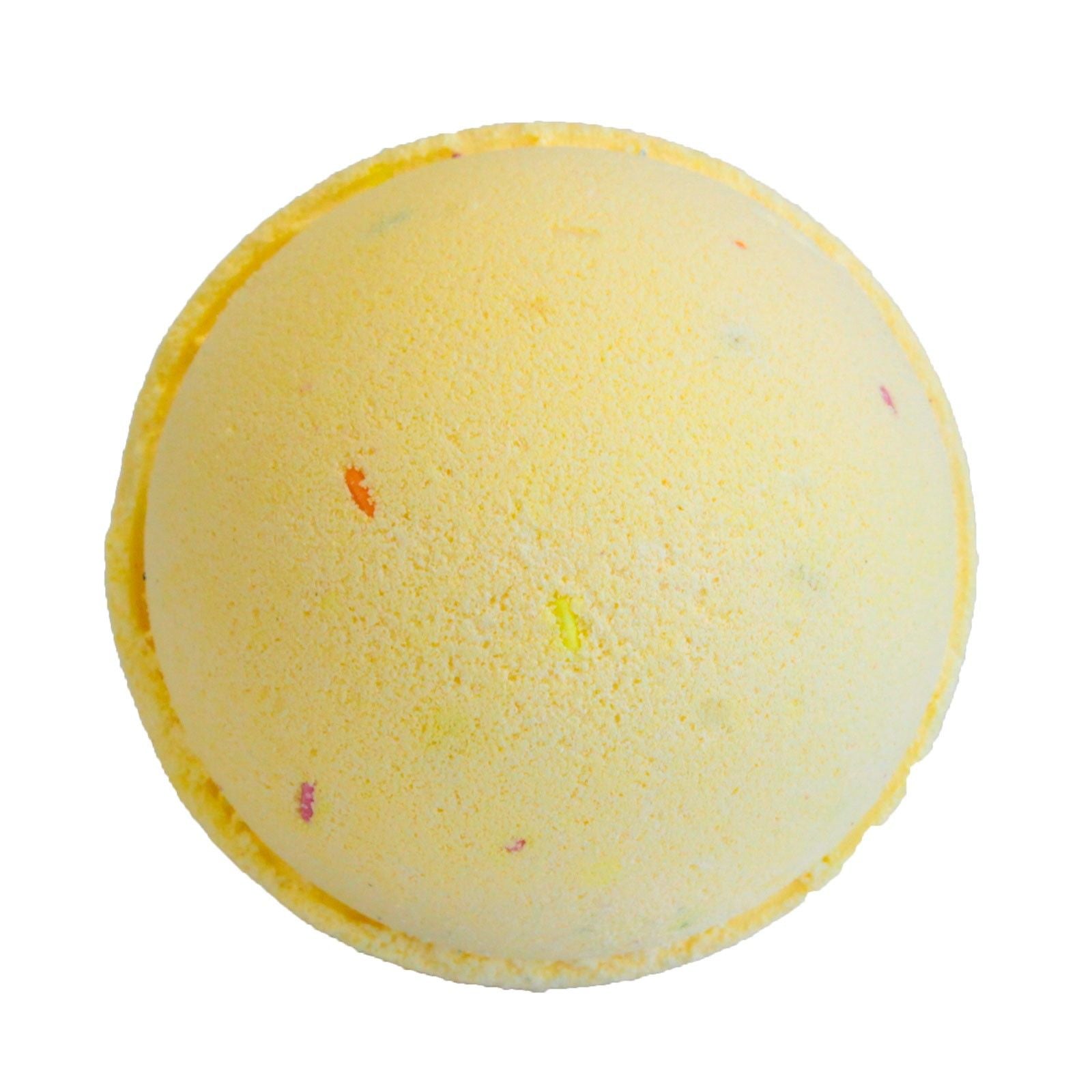 Yellow bath bomb with specks on a white background