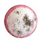 Round bath bomb with pink exterior and white interior speckled with black, on a white background