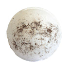 White bath bomb with chocolate shavings on a white background