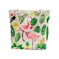 Tote bag with flamingo and tropical leaf design on a white background