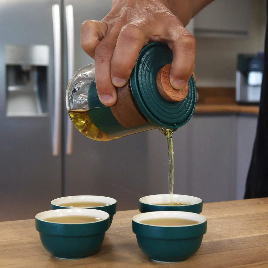 Travel Mountain Teapot Set with 4 Cups - Travel Pack pouring tea into four matching cups.