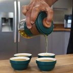 Travel Mountain Teapot Set with 4 Cups - Travel Pack pouring tea into four matching cups.