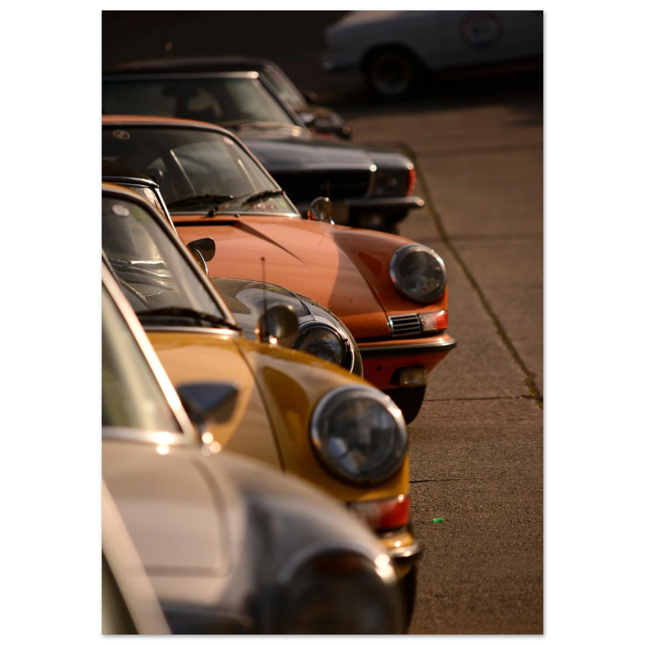 Vintage cars parked in a row on a street