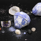 Decorative stones with blue and white patterns on a black surface