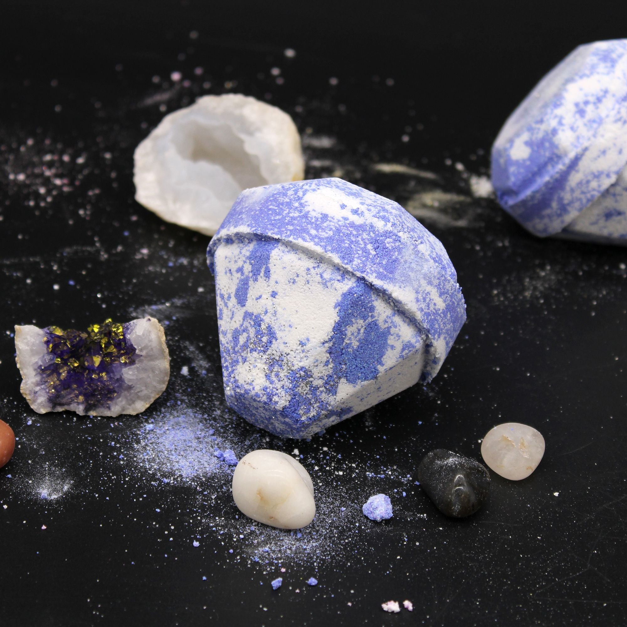 Decorative stones with blue and white patterns on a black surface