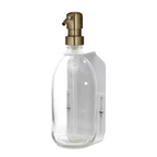 Clear glass bottle with a gold pump dispenser on a dark blue background