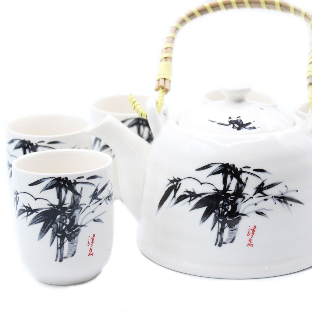 Ceramic teapot and cups with bamboo design on a white background