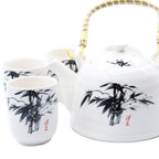 Ceramic teapot and cups with bamboo design on a white background