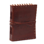 Brown leather notebook with stitching details on a white background
