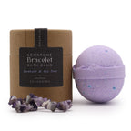Purple bath bomb with amethyst stones and packaging on a white background