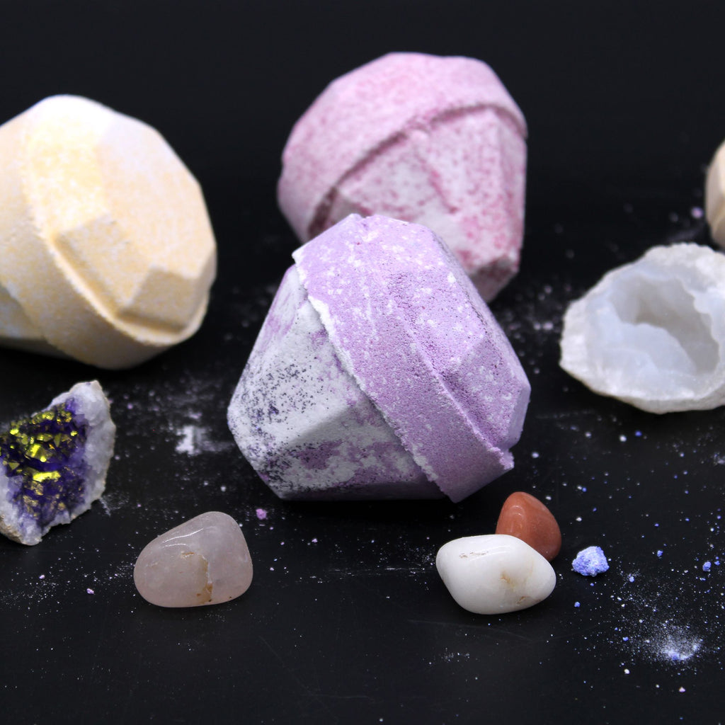Colorful bath bombs with natural stones on a black background