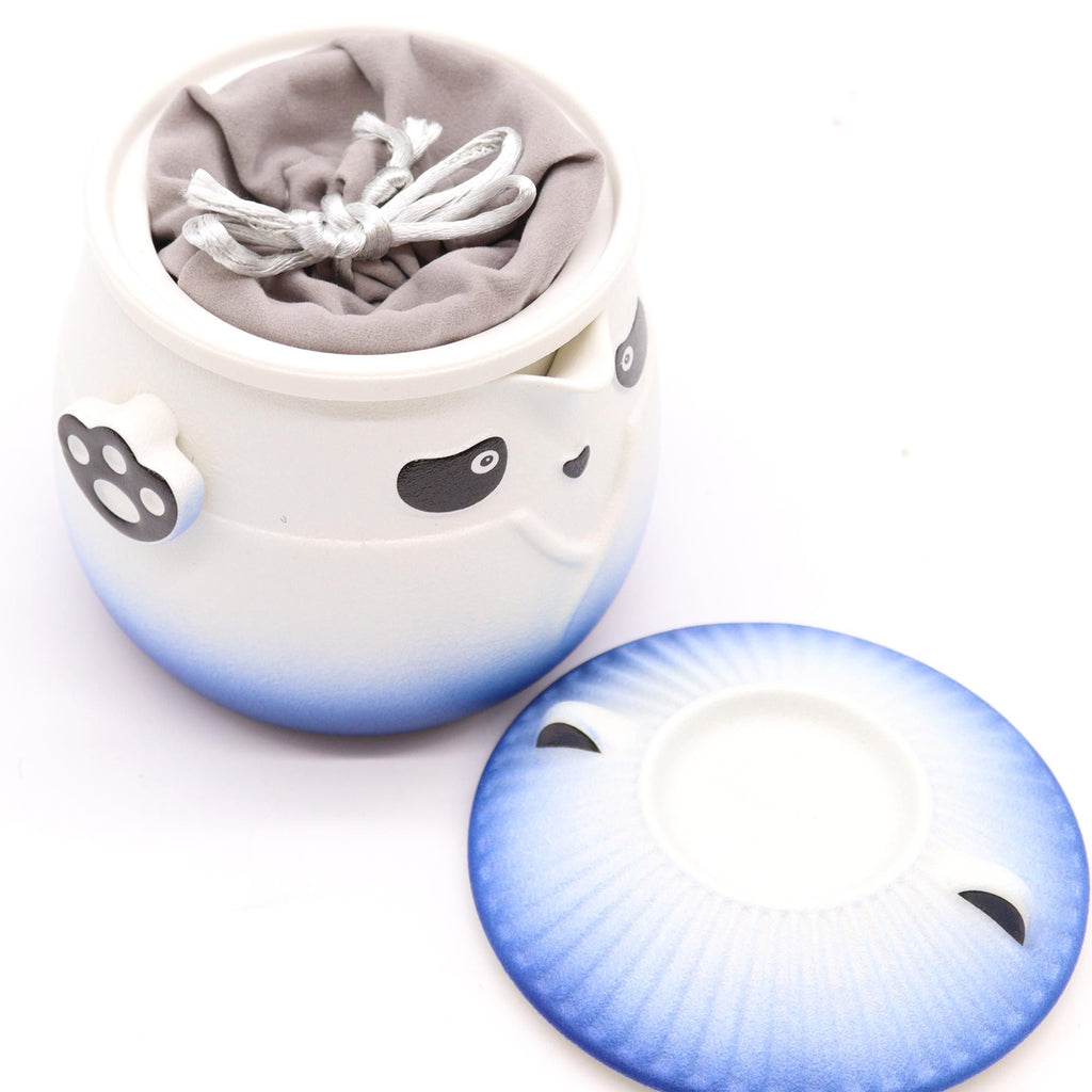 Ceramic pot with a gradient blue to white design and gray interior.