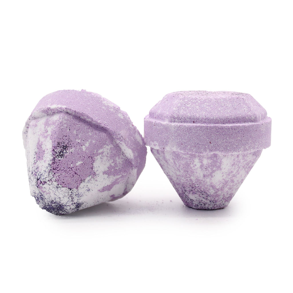 Two purple bath bombs with a textured surface on a white background