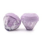 Two purple bath bombs with a textured surface on a white background