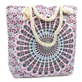 Floral patterned tote bag with rope handles on a white background