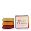 Bath fizzers stacked together with the packaging on thd side