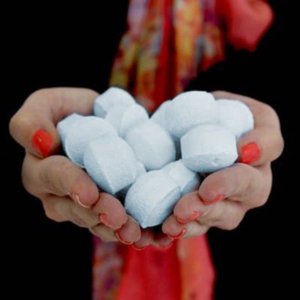 Mini blue bath bombs on the hand