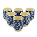 Set of six ceramic cups with blue floral pattern on a white background