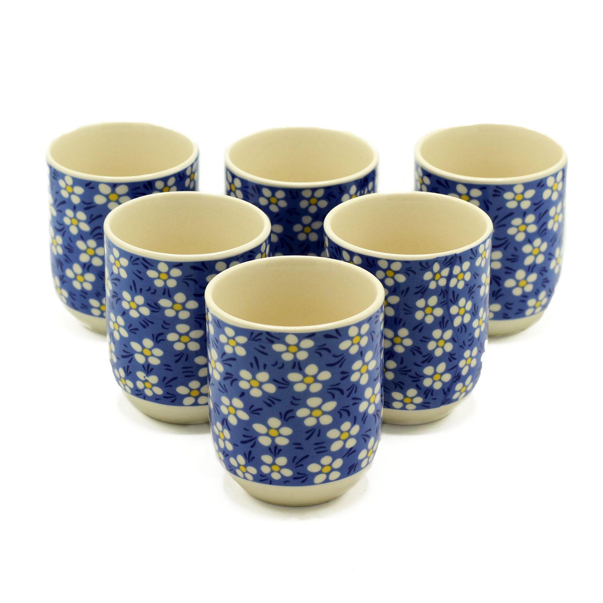 Set of six ceramic cups with blue floral pattern on a white background