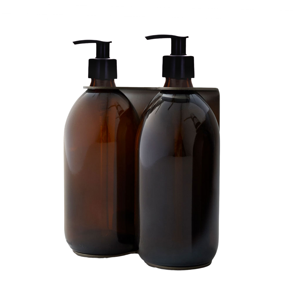 Two brown glass bottles with black pump dispensers on a white background